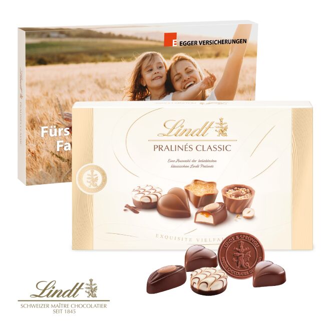Firmengeschenk Lindt Pralinés Classic – bunt – mit bedrucktem Etikett 125g als hochwertiges Werbemittel für Geschäftspartner und Kunden