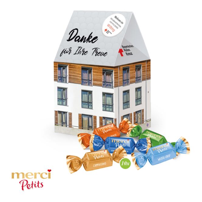 Firmengeschenk Lindt Lindor 3D-Haus – weihnachtlich – mit bedrucktem Etikett als Weihnachtsgeschenk für Kunden und Partner
